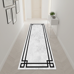 Minimal ve çağdaş estetikte tasarlanmış yolluk halı, açık renkli zemin üzerinde geometrik siyah çerçeve detayları içerir. Temiz çizgiler ve sade tasarım ile modern ve dengeli bir görünüm sunar.