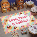 Pop art ve illüstratif stilin birleştiği modern dekoratif halı tasarımı, merkezde bulut formu içinde büyük ve yuvarlak tipografi ile yazılmış “Love, Peace & Cookies” ifadesini içerir. Pastel tonlu zemin üzerinde şeker, çikolata, cupcake ve kurabiye figürleri ile zenginleştirilmiş tatlı temalı grafik kompozisyon bulunur.